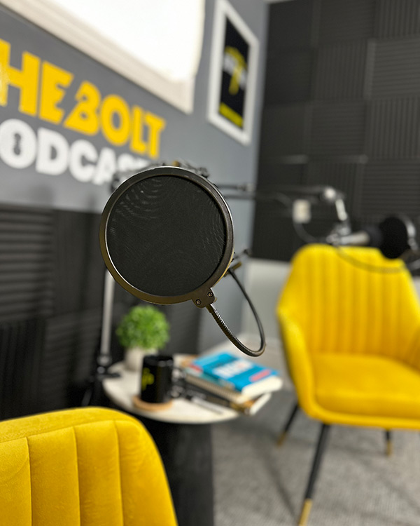 podcast studio, gold chairs, microphone