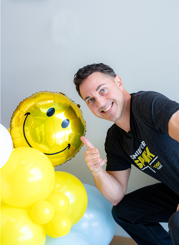Todd Bertsch with a smiley face balloon